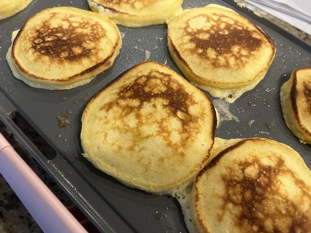 Eggnog pancakes on a griddle